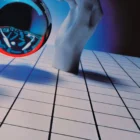 Hand holding crystal ball over grid